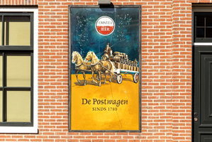 Nostalgisch Amstel-reclamebord met postkoets op de bakstenen gevel van De Postwagen