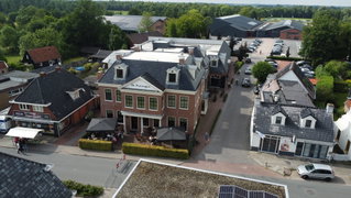 Luchtfoto van De Postwagen met de zalen en het terras aan de Hoofdstraat in Tolbert