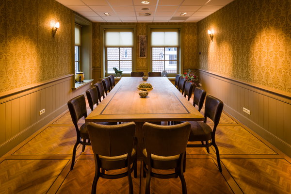Vergaderzaal Herenkamer van De Postwagen met lange houten tafel voor het raam